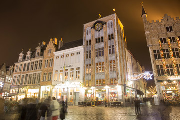 Bruges, Belgium - November 24, 2018: Central Bruges Market Square by night decorated at Christmas.