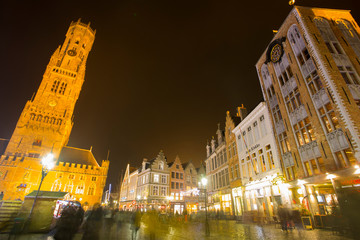 Fototapeta na wymiar Bruges, Belgium - November 24, 2018: Central Bruges Market Square by night decorated at Christmas.