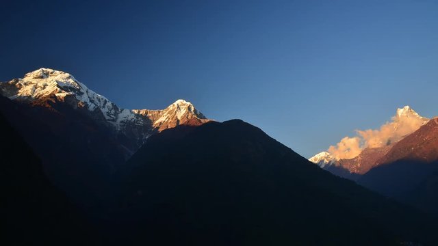 ay to night timelapse clip of the Annapurna South, Hinchuli and Machhapuchhre peak during sunset in Chhomrong, Nepal.