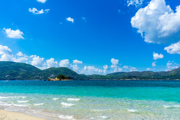 Greece, Zakynthos, Green mountainous nature landscape behind caribbean azure blue beach