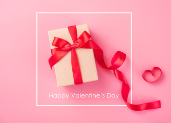 Kraft Gift box with beautful red ribbon and rose, concept of Valentine's, anniversary, mother's day and birthday greeting, copy space, top view.