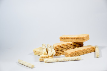 Wafer stick Stuffed with vanilla cream and milk on a white background