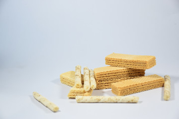 Wafer stick Stuffed with vanilla cream and milk on a white background