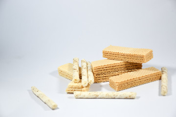 Wafer stick Stuffed with vanilla cream and milk on a white background
