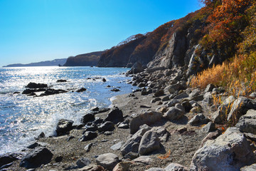 rocky seashore, water splashing on rocks in the sea