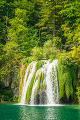 Fototapeta na wymiar Waterfall at a turquoise lake. The Plitvice Lakes National Park, Croatia, Europe.