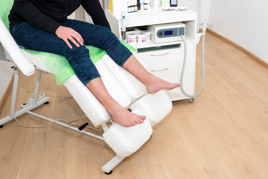 Podology treatment. Patient waiting for doctor podiatrist or dermatologist in modern clinic