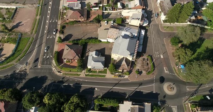 Quiet local streets of Windsor town downtown in regional NSW near Sydney in aerial flying over roof tops of local houses, hotels, pubs and services.
