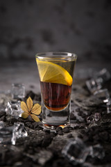 Alcoholic Black Magic cocktail in shot glass (shooters). Cool drink from strong vodka, whiskey and sweet liqueurs. Easy Bartenders Recipes and Ideas