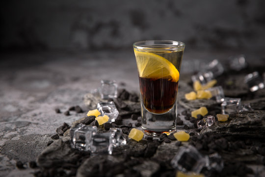 Alcoholic Black Magic Cocktail In Shot Glass (shooters). Cool Drink From Strong Vodka, Whiskey And Sweet Liqueurs. Easy Bartenders Recipes And Ideas