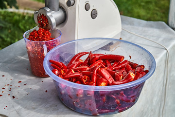Red hot chili pepper. Making red hot chili pepper mash in a grinder