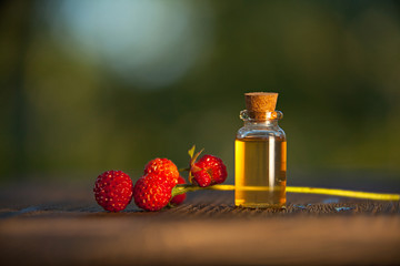Essence of Wild strawberry on table in beautiful glass jar