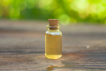 Essence of flowers on table in beautiful glass jar