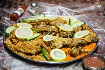 Fototapeta na wymiar Lamb salona and chicken mandi served on the floor at an Emirati restaurant in Dubai, United Arab Emirates