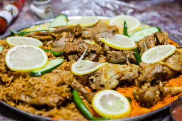 Fototapeta na wymiar Lamb salona and chicken mandi served on the floor at an Emirati restaurant in Dubai, United Arab Emirates