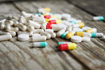 Drugs in medical container. Box on wooden background.