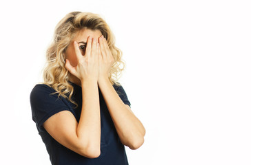 Beautiful young emotional girl closes her eyes to an isolated white background. Do not want to see