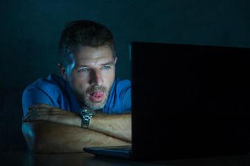 young aroused and excited sex addict man watching porn mobile online in laptop computer light night...
