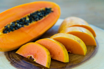 cutting papaya on wooden table