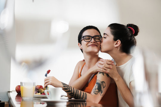 Young Lesbian Couple Kissing and Romantic During Breakfast