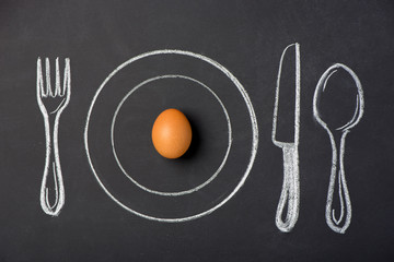 Boiled chicken eggs on a plate in the figure on a chalk board