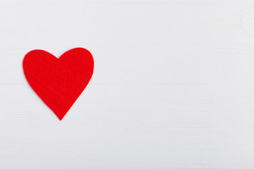 Obraz na płótnie Canvas Red heart on a white background. Harvesting cards for Valentine's Day. Place for text, copy space.