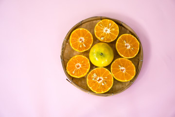 oranges on a pink background