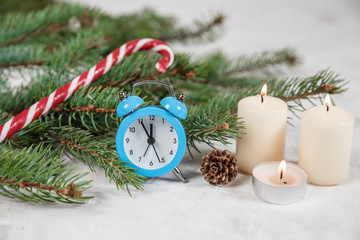 Fototapeta na wymiar Christmas holiday background with vintage alarm-clock, Candy canes plastering background.