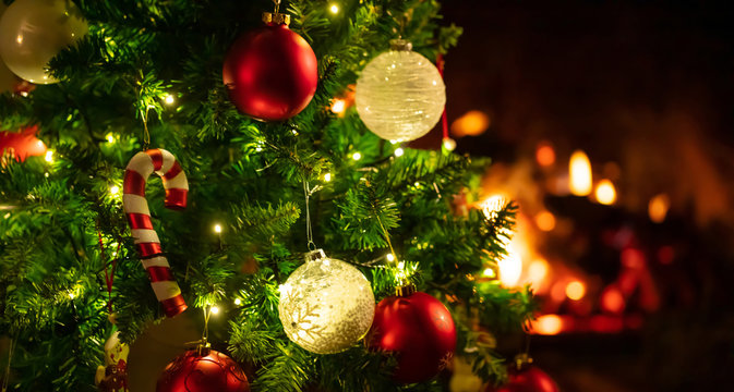 Christmas tree close up on blurred burning fireplace background Stock Photo  | Adobe Stock