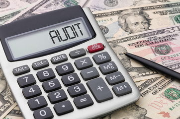 Calculator with dollar bills - Audit