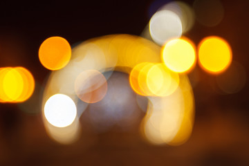 Fototapeta premium Blurred background of colored lights in the form of luminous arches. Image of abstract blurred bokeh background with colored lights. Christmas lights, blur, bokeh, bokeh lights, bokeh background