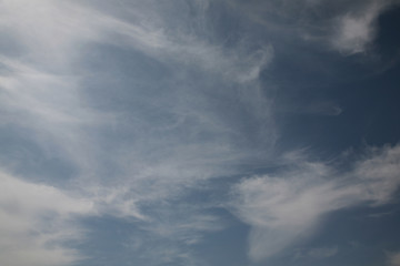 Obraz premium Beautiful pictures of the clouds illuminated by the daylight of heaven. Bright background of the usual sky decorated patterns from the clouds. The best clouds and sky adorn the blue sky background. 