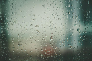 Background and wallpaper by rainy drop and water drops on window glass.