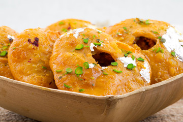 Indian Traditional Sweet Kachori Also Know As Mawa Kachori, Kachauri or Kachodi, Stuffed Kachori With Condensed Milk, Cheese and Dry Fruits And Served With Sugar Syrup
