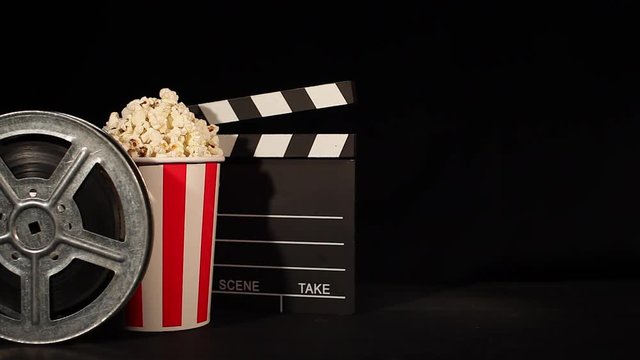 film reel with popcorn and clapboard