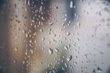 Background and wallpaper by rainy drop and water drops on window glass.