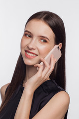 Portrait of a smiling woman talking by phone