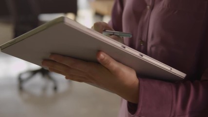 working on a mobile device. Businessman or businesswoman working on mobile platform managing a project - Powered by Adobe