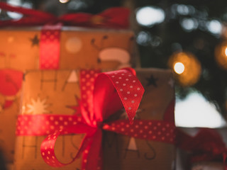 Christmas Gifts closeup. In background Christmas tree.