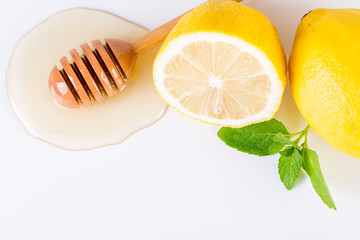 Honey with lemon and mint on white background