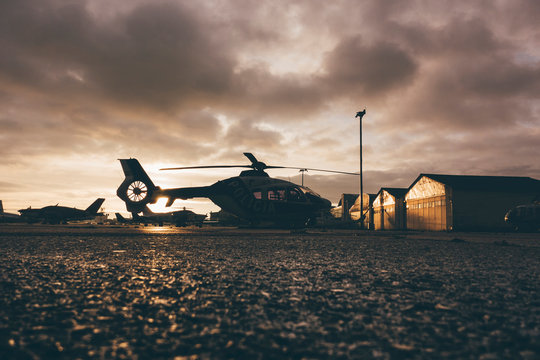 Helicopter on landing place during sunset
