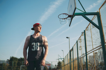 guy in a red baseball cap on the basketball court