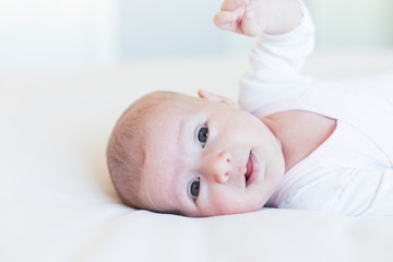 close up portrait of a beautiful baby on white background at home