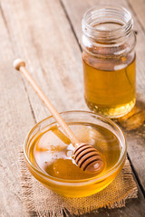 Honey in glass bowl on wooden table