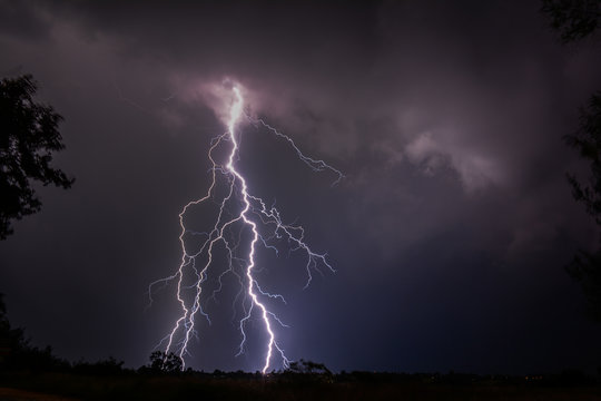 Cloud to ground urban lightning strike at night 