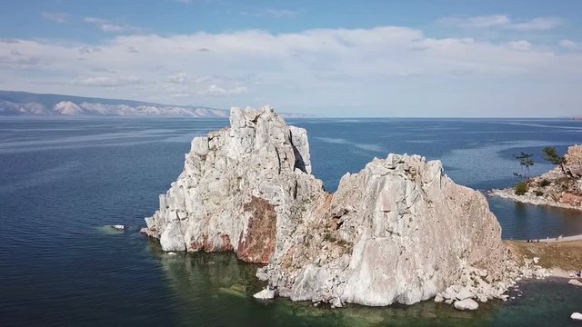 Tranquil Aerial View of the Baikal Bay Shamanka. White ship in calm bay at great lake. Olkhon Island, Baikal. Drone footage.