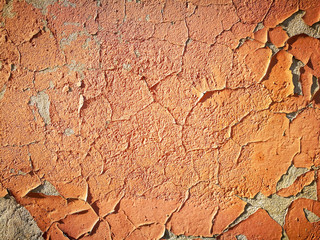 Old cracked wall with orange paint as background
