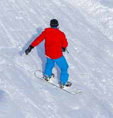 A man snowboarding a mountain in the snow in winter