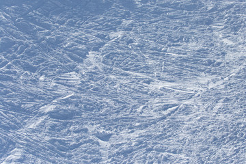 Traces of skiers on white snow in the mountains