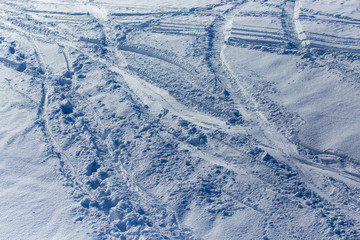 Traces of skiers on white snow in the mountains